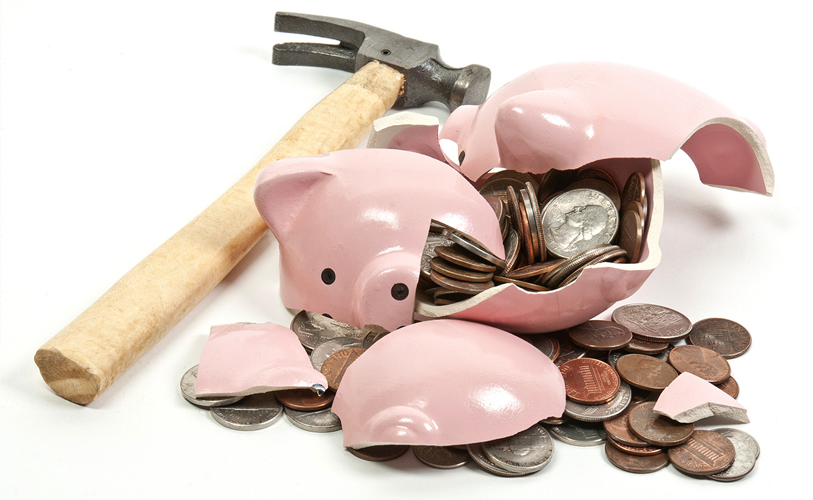 Hammer, smashed piggy bank and coins