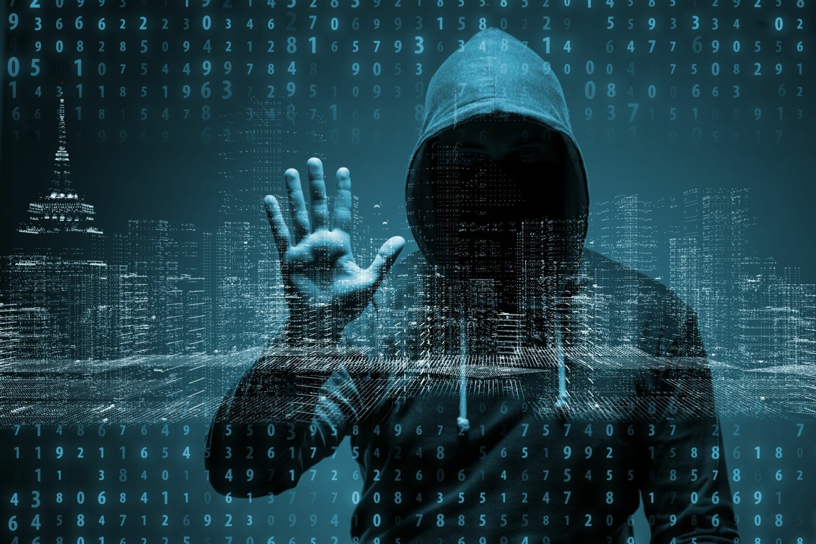 Man with hood up and hand on data screen